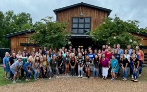  The TSMS staff pose in front of a barn